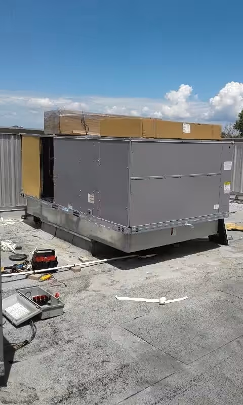 A technician performing HVAC maintenance on a unit, ensuring optimal performance and safety.