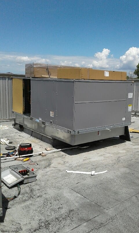A technician performing HVAC maintenance on a unit, ensuring optimal performance and safety.